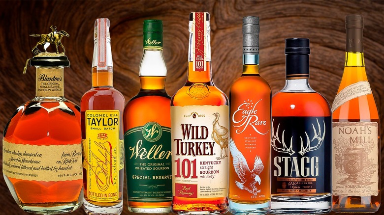 selection of best bourbon bottles and old fashioned cocktail with orange peel